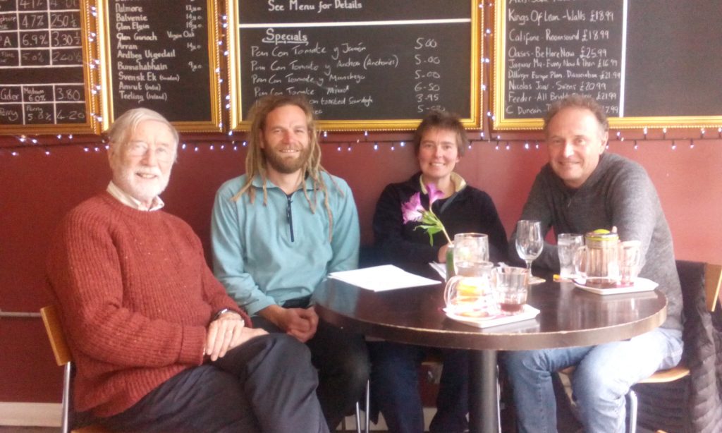 Image of the first four members of the cooperative, sat around a table