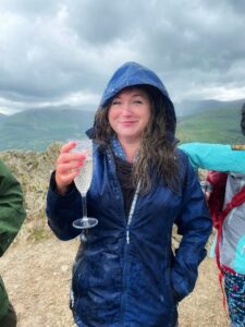 Penny Bradshaw raising a glass of bubbly to the camera