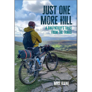 Front cover image of Mike Raine's Just One More Hill. Image of a man I'n yellow waterproof cycling jacket with rucksack on his back and mountain bike with bike packing kit on a stoney path looking out over green valley landscape below
