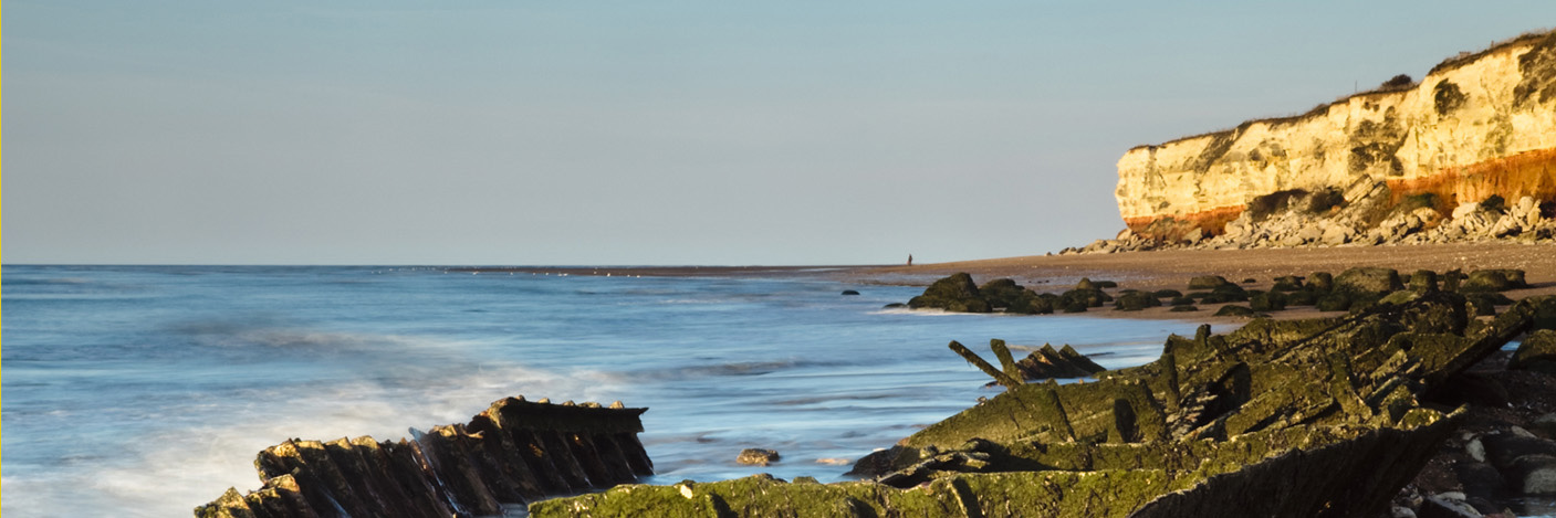 Panoramic shaped image of English coastline with white chalky cliffs and sea